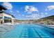 Inviting community pool featuring clear blue water, multiple entrances, and surrounding lounge chairs under a sunny sky at 804 Cassa Clubhouse Way, Knightdale, NC 27545