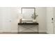 Entryway table featuring a lamp, decorative bowl, and olive branches in a vase at 804 Cassa Clubhouse Way, Knightdale, NC 27545