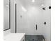 Bathroom with glass shower, white tile, dark shower hardware and floors at 810 Maple Berry Ln # 104, Raleigh, NC 27607