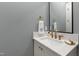 Bathroom vanity features a white counter top, mirror, and gold fixtures at 810 Maple Berry Ln # 104, Raleigh, NC 27607