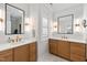 Bathroom featuring double vanities with granite countertops, modern fixtures, mirrors, and ample cabinet space at 810 Maple Berry Ln # 104, Raleigh, NC 27607