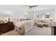 Cozy bedroom featuring a comfortable bed, seating area, and soft natural lighting from the window at 810 Maple Berry Ln # 104, Raleigh, NC 27607