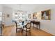 Dining room features modern chandelier, window seating, and wood floors at 810 Maple Berry Ln # 104, Raleigh, NC 27607