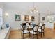 Inviting dining room features a glass table, six chairs, accent lighting, and a window bench at 810 Maple Berry Ln # 104, Raleigh, NC 27607