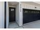 Close-up of a home's front door and garage, showcasing modern design elements and address at 810 Maple Berry Ln # 104, Raleigh, NC 27607