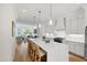 Open kitchen showcases an island with barstool seating, modern pendant lights, and a seamless transition to living room at 810 Maple Berry Ln # 104, Raleigh, NC 27607