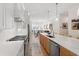 Open kitchen layout showcasing stainless steel appliances, a kitchen island, and a view into the dining area at 810 Maple Berry Ln # 104, Raleigh, NC 27607