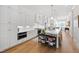 Modern kitchen with white cabinets, hardwood floors, stainless steel appliances, and spacious island at 810 Maple Berry Ln # 104, Raleigh, NC 27607
