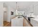 Kitchen features a large island, white cabinets, and modern appliances at 810 Maple Berry Ln # 104, Raleigh, NC 27607