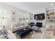 Bright living room with hardwood floors, fireplace, large windows and comfortable furnishings at 810 Maple Berry Ln # 104, Raleigh, NC 27607