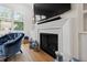 Living room fireplace with built-in shelving, providing a cozy focal point and ample storage space at 810 Maple Berry Ln # 104, Raleigh, NC 27607