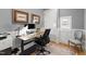 Comfortable home office with wood desk, modern chair, wall art, and ample natural light at 810 Maple Berry Ln # 104, Raleigh, NC 27607