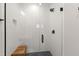 Walk-in shower with a glass door, rain shower head, and a wooden bench at 810 Maple Berry Ln # 104, Raleigh, NC 27607