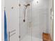 Modern shower with glass enclosure, gold fixtures, marble tile, and wooden bench at 810 Maple Berry Ln # 104, Raleigh, NC 27607