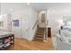 Bright entryway featuring a staircase with neutral carpet and an adjacent hallway at 810 Maple Berry Ln # 104, Raleigh, NC 27607