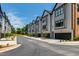 Street view of modern townhomes with black trim and well-maintained landscaping at 810 Maple Berry Ln # 104, Raleigh, NC 27607