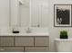 A well-lit bathroom features a modern vanity and toilet with stylish artwork at 909 Crossbill Dr, Knightdale, NC 27545