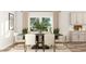 Dining area with a large table, chic seating, modern decor and access to the kitchen at 909 Crossbill Dr, Knightdale, NC 27545