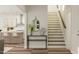 Inviting entryway featuring a modern console table, staircase, and a glimpse of the kitchen at 909 Crossbill Dr, Knightdale, NC 27545
