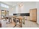 Modern kitchen with sleek countertops, stainless steel appliances, and stylish wooden table seating at 909 Crossbill Dr, Knightdale, NC 27545