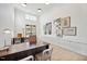Bright office with natural light, modern décor, built-in storage, and a large wooden desk at 909 Crossbill Dr, Knightdale, NC 27545