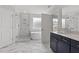 Luxurious bathroom with marble tile, glass shower, freestanding tub, and modern vanity at 95 Black Walnut Dr # 191, Garner, NC 27529