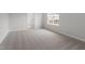 The bedroom has neutral carpet, a window with backyard views, and a hallway entrance at 95 Black Walnut Dr # 191, Garner, NC 27529