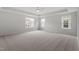 Spacious bedroom featuring plush carpeting, ceiling fan, and abundant natural light at 95 Black Walnut Dr # 191, Garner, NC 27529