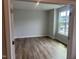Bright, empty bedroom with wood flooring, large window, and neutral paint at 95 Black Walnut Dr # 191, Garner, NC 27529