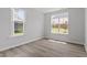 Bedroom with wood floors and a view of the yard through two large windows providing lots of natural light at 95 Black Walnut Dr # 191, Garner, NC 27529