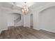 Open dining room showcasing coffered ceilings, chandelier, hardwood floors and arched doorway at 95 Black Walnut Dr # 191, Garner, NC 27529