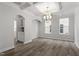 Dining room with decorative chandelier, coffered ceiling and hardwood floors at 95 Black Walnut Dr # 191, Garner, NC 27529