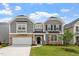 Charming two-story home featuring stone accents, gray siding and a well-manicured lawn at 95 Black Walnut Dr # 191, Garner, NC 27529