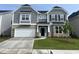 Charming two-story home features stone accents, gray siding, manicured lawn, and a two-car garage at 95 Black Walnut Dr # 191, Garner, NC 27529