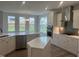 Modern kitchen with white cabinets, stainless appliances, island, and tile backsplash at 95 Black Walnut Dr # 191, Garner, NC 27529