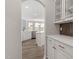 Open kitchen view with white cabinets, island, and modern finishes at 95 Black Walnut Dr # 191, Garner, NC 27529