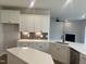 Modern kitchen showcasing white cabinets, gray backsplash, and open layout with a fireplace view at 95 Black Walnut Dr # 191, Garner, NC 27529