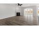 Spacious living room with hardwood floors, fireplace, ceiling fan and abundant natural light at 95 Black Walnut Dr # 191, Garner, NC 27529