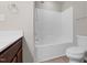 Bright bathroom featuring a tub with shower, tile floors, and vanity with dark wood cabinets at 9805 Precious Stone Dr, Wake Forest, NC 27587