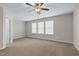 Spacious bedroom with three large windows and neutral carpet at 9805 Precious Stone Dr, Wake Forest, NC 27587