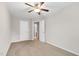 Bedroom featuring carpet flooring, ceiling fan, and multiple doors, offering both comfort and convenience at 9805 Precious Stone Dr, Wake Forest, NC 27587