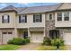 Charming townhome with stone accents, a one-car garage, tidy landscaping, and classic curb appeal at 9805 Precious Stone Dr, Wake Forest, NC 27587
