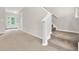 Foyer with stairs, neutral walls and carpeted living room entrance at 9805 Precious Stone Dr, Wake Forest, NC 27587