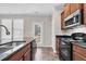 Well-lit kitchen with stainless steel appliances and dark granite countertops at 9805 Precious Stone Dr, Wake Forest, NC 27587