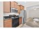Kitchen with stainless steel fridge, microwave and black electric range at 9805 Precious Stone Dr, Wake Forest, NC 27587
