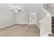 Bright living room with ceiling fan, and view of foyer with stairs at 9805 Precious Stone Dr, Wake Forest, NC 27587