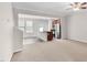 Bright, carpeted living room flowing into the kitchen with stainless steel appliances at 9805 Precious Stone Dr, Wake Forest, NC 27587