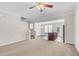 Bright, carpeted living room flowing into the kitchen with stainless steel appliances and modern lighting at 9805 Precious Stone Dr, Wake Forest, NC 27587