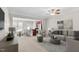 Cozy living room with modern furniture, ceiling fan, and an open view to the dining and kitchen area at 9805 Precious Stone Dr, Wake Forest, NC 27587