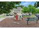 Charming community playground with a small playhouse, bench, and ample space for children to enjoy at 9805 Precious Stone Dr, Wake Forest, NC 27587